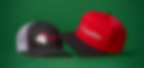 Baseball caps against a green background