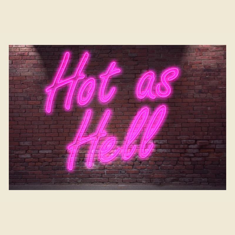 Neon sign Hot as Hell on brick wall
