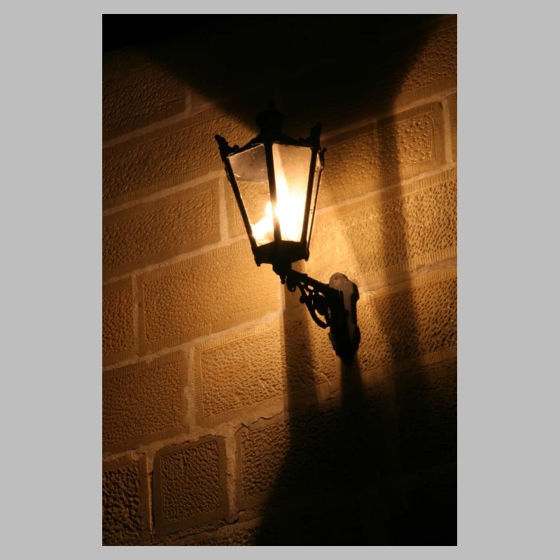 Night lantern on brick wall