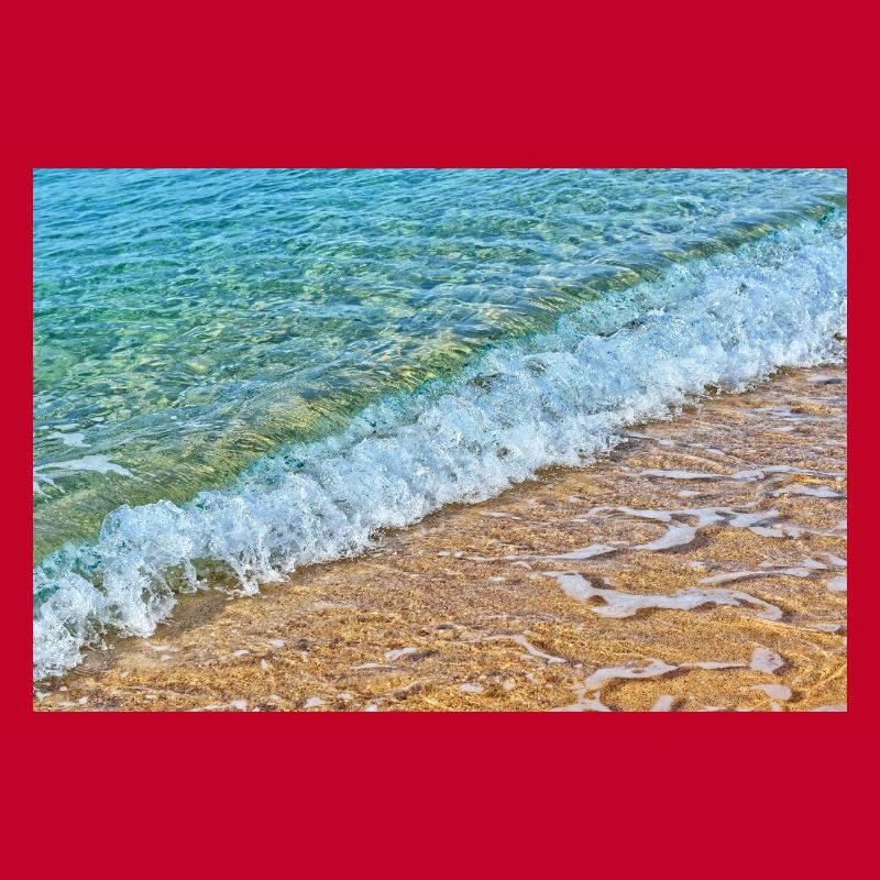 Crystal waves on golden sand beach