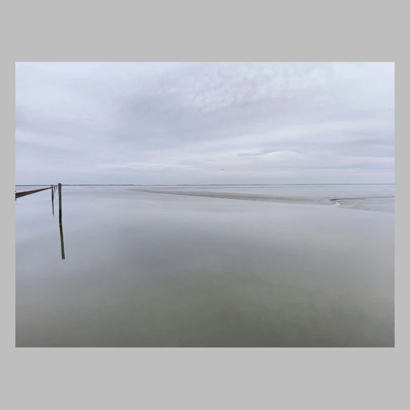 Silent seashore with sky reflection