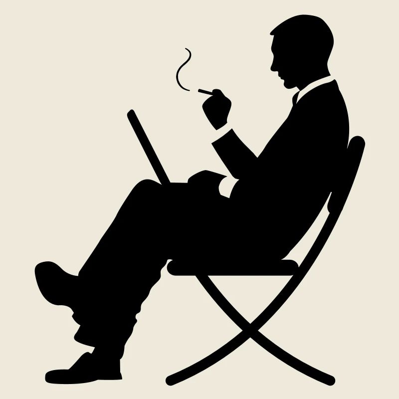 A manager working on laptop and smokes