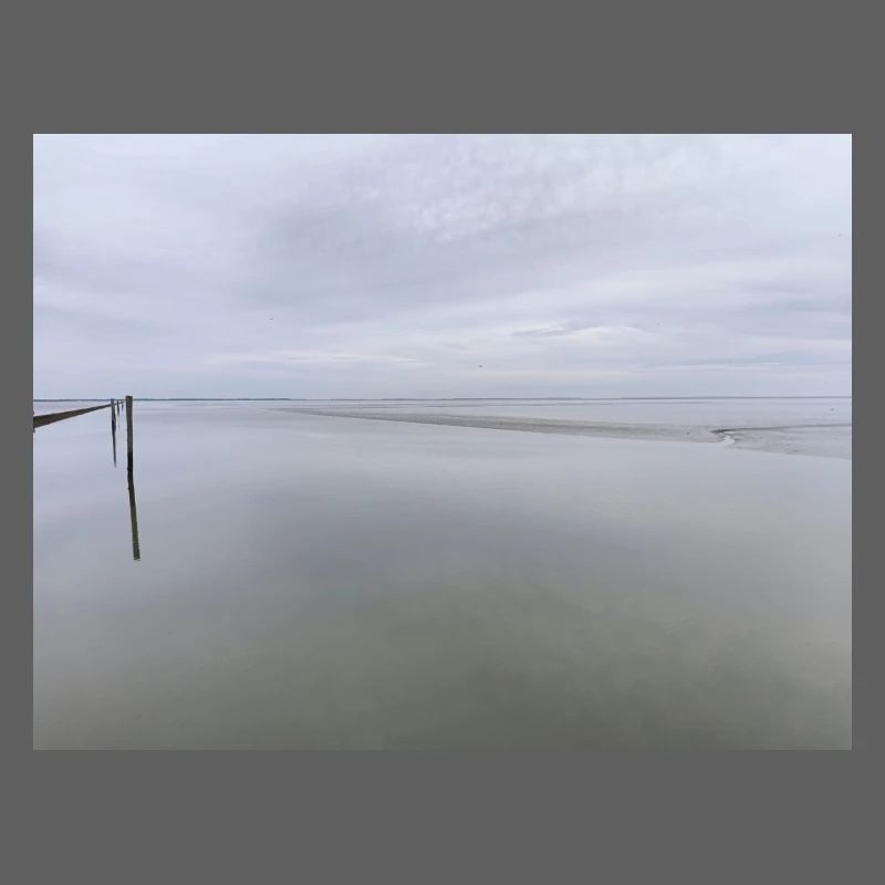 Silent seashore with sky reflection