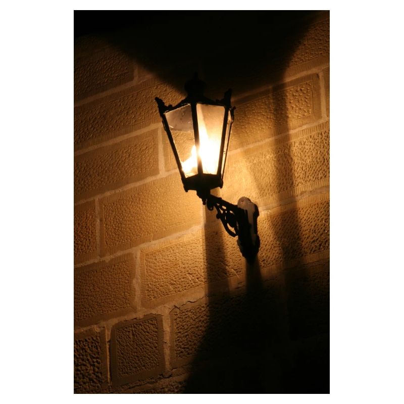 Night lantern on brick wall