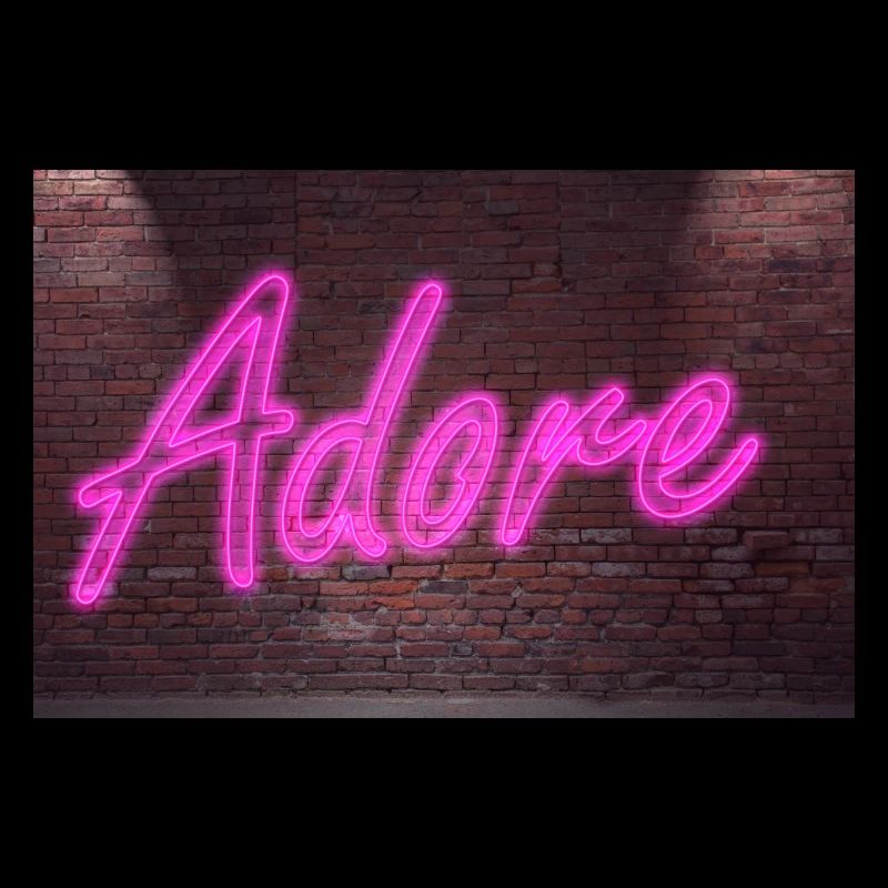 Neon adore lettering on Brick Wall at night