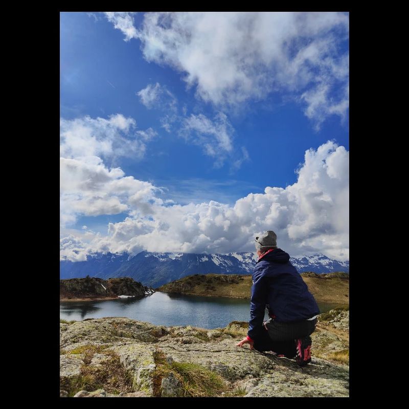 Hiker facing the alpine sky