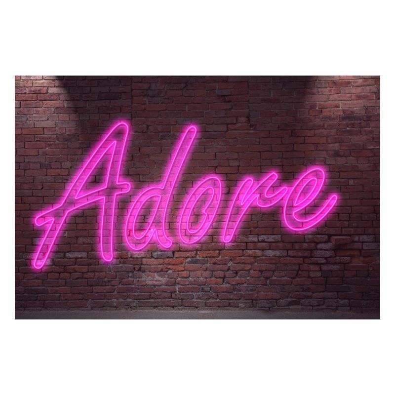 Neon adore lettering on Brick Wall at night