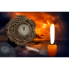 A clock illuminated by candles.