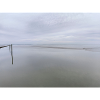 Silent seashore with sky reflection