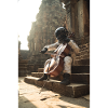 Astronaut Playing Cello on Ancient Steps