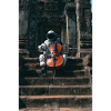 Astronaut Playing Cello at Ancient Temple