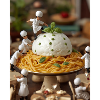 Miniature cooks on pasta table