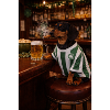 Dachshund in pub jersey with shamrock