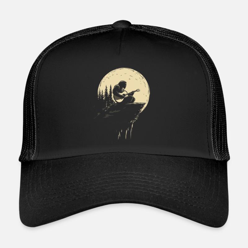 Guitar player in the moonlight on rocks Trucker Cap