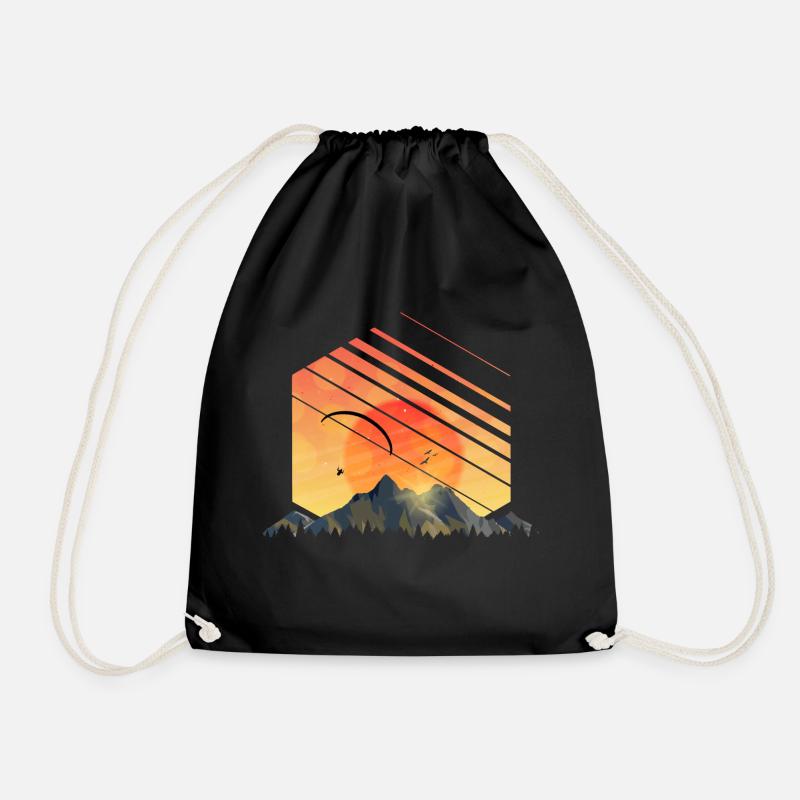 Paragliding over the mountains at sunset - Drawstring Bag - black