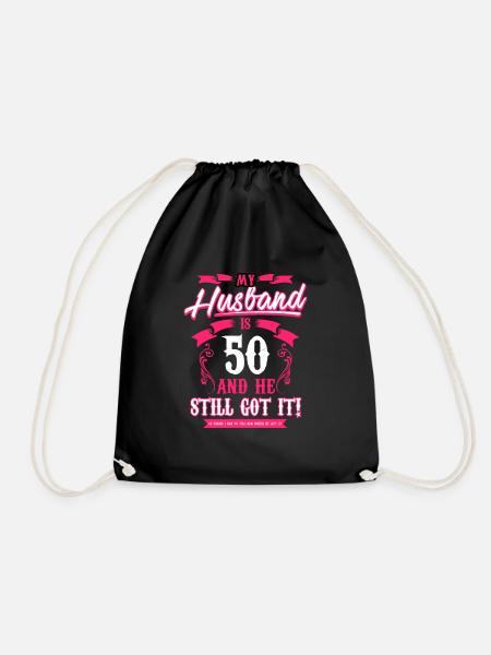My Husband is 50 T Shirt and he still got it funny - Drawstring Bag - black