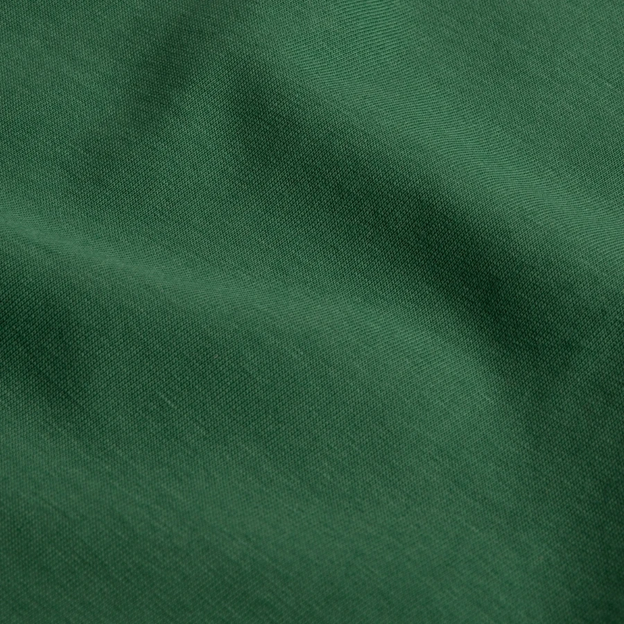 Grindelwald badge on a kids t-shirt by russell, bottle green, close-up