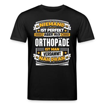 Lustiger Spruch Orthopäde - Stanley/Stella Unisex Bio-T-Shirt CREATOR  - Schwarz - Vorne - Alina (178cm) & Michal (187cm)