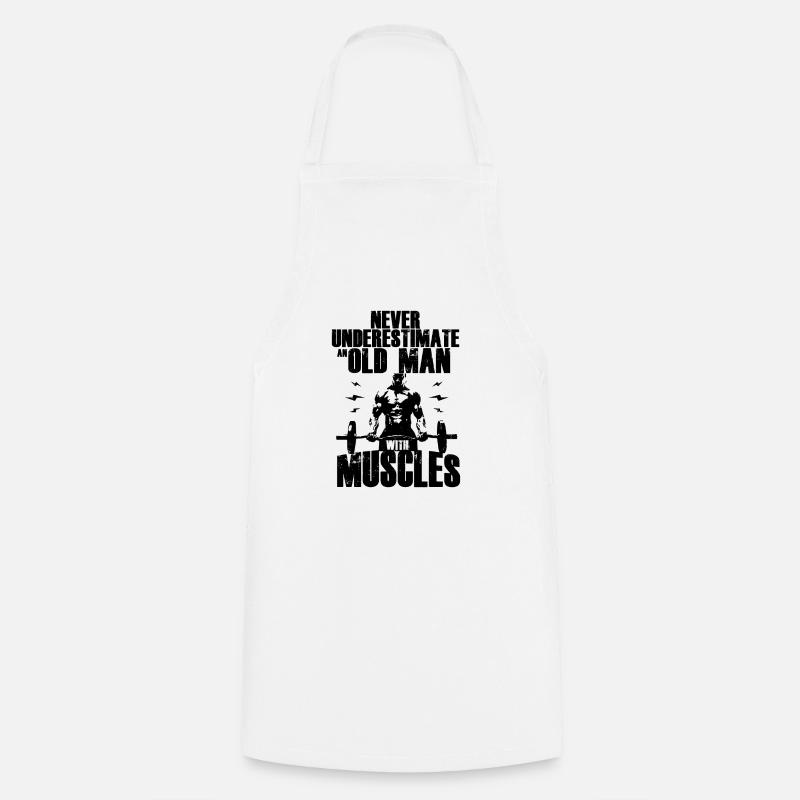 Never Underestimate An Old Man With Muscles - Cooking Apron - white