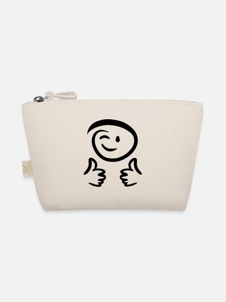 Le visage fait un clin d’œil, montre deux pouces en l’air. Émoticône. - Trousse biologique - nature - Devant