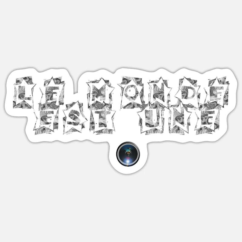Le monde est une camera Sticker taille S (10 x 10 cm)