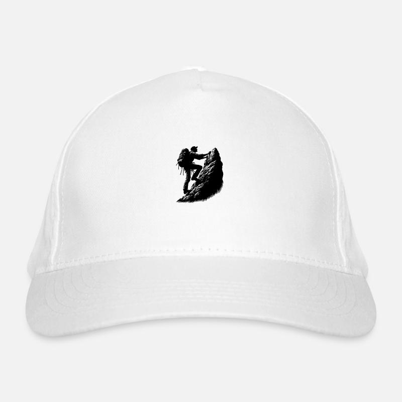Man climbing on mountain top rocks Organic Baseball Cap