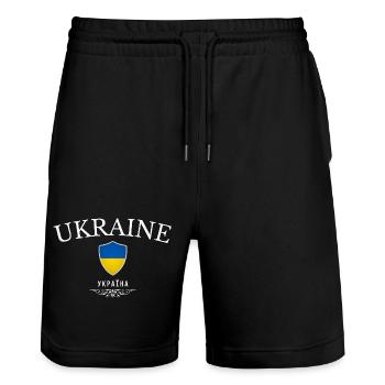 Ursprünglich aus der Ukraine, geboren in der Ukraine - Stanley/Stella Unisex Bio Joggingshorts Trainer  - Schwarz - Vorne - Nik (191cm) & Marisol (170cm)