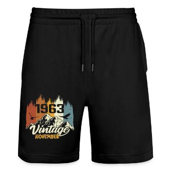 62nd birthday - legendary since November 1963 - Stanley/Stella Trainer Unisex Organic Jogging Shorts - black - Front - Nik (191cm) & Marisol (170cm)