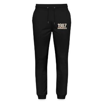 1987 Jahrgang 1987 Geburtstag 1987 Retro 1987 - Stanley/Stella Unisex Bio Jogginghose Mover  - Schwarz - Vorne - Marisol (170cm) & Nik (191cm)