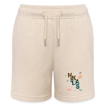 NIKLAS - Beautiful boy name with dinosaur - Stanley/Stella MINI BOLTER Organic Teen Jogging Shorts - soft Ecru - Front