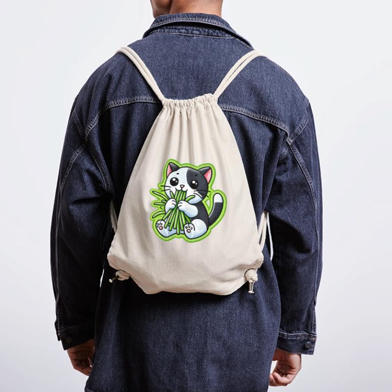 Mignon chat noir et blanc mangeant de l’herbe verte Sac à cordon recyclé Stanley/Stella