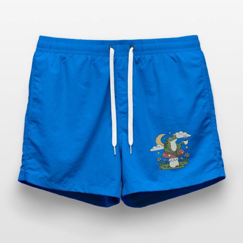 A frog with a cup sits on a toadstool Swim Trunks