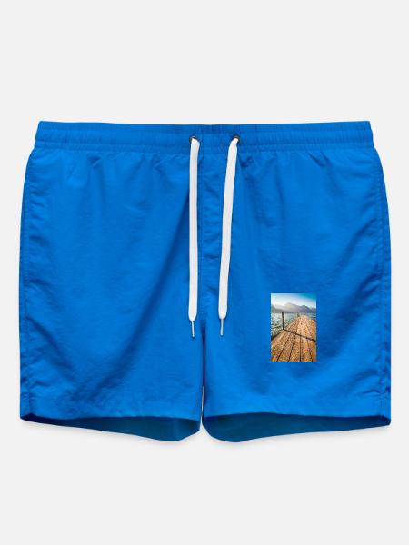 Wooden jetty at the mountain lake in the sunlight - Swim Trunks - cobalt blue