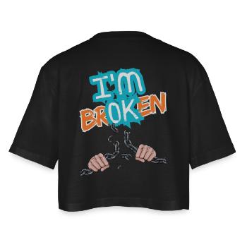 Hands breaking a chain with an inscription - Women’s Oversized Cropped T-Shirt - black - Back - AI Model Female 172 light (172cm)