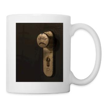 A doorknob with a bad tempered face painted on it - Mug - white - Right