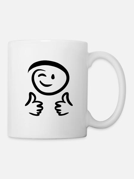 Le visage fait un clin d’œil, montre deux pouces en l’air. Émoticône. - Mug blanc - blanc