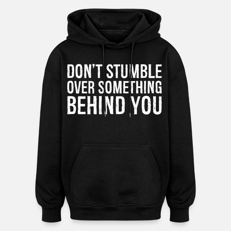 don't stumble over something behind you - Oversized Unisex Hoodie - black