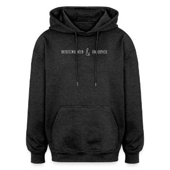 Overstimulated & Underpaid Typo Saying - Oversized Unisex Hoodie - charcoal grey - Front - Noah (186cm)