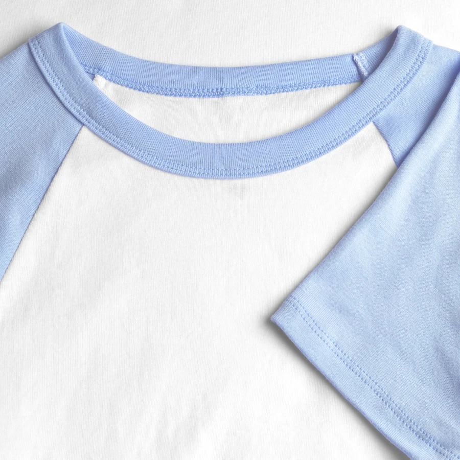 Interlaken badge on a women's cropped baseball t-shirt, white/light blue, close-up