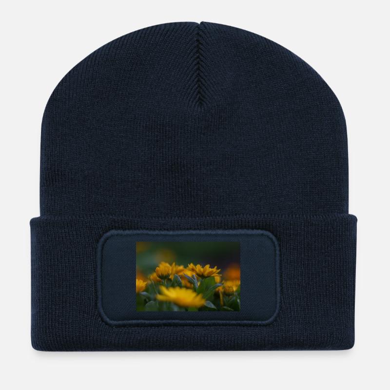 Vibrant yellow flowers bloom amid lush green folia - Recycled Patch Beanie - french navy