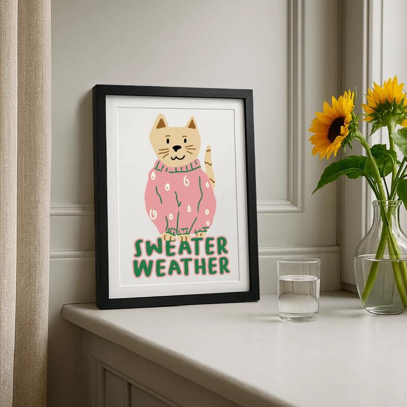 Chat en pull rose – Temps de pull Affiche encadrée (27 × 37 cm)