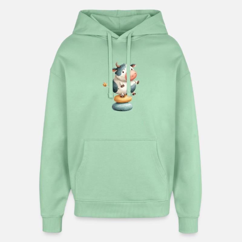 Vache en équilibre sur des donuts - Sweat à capuche unisexe Stanley/Stella Oversized - jade brumeux