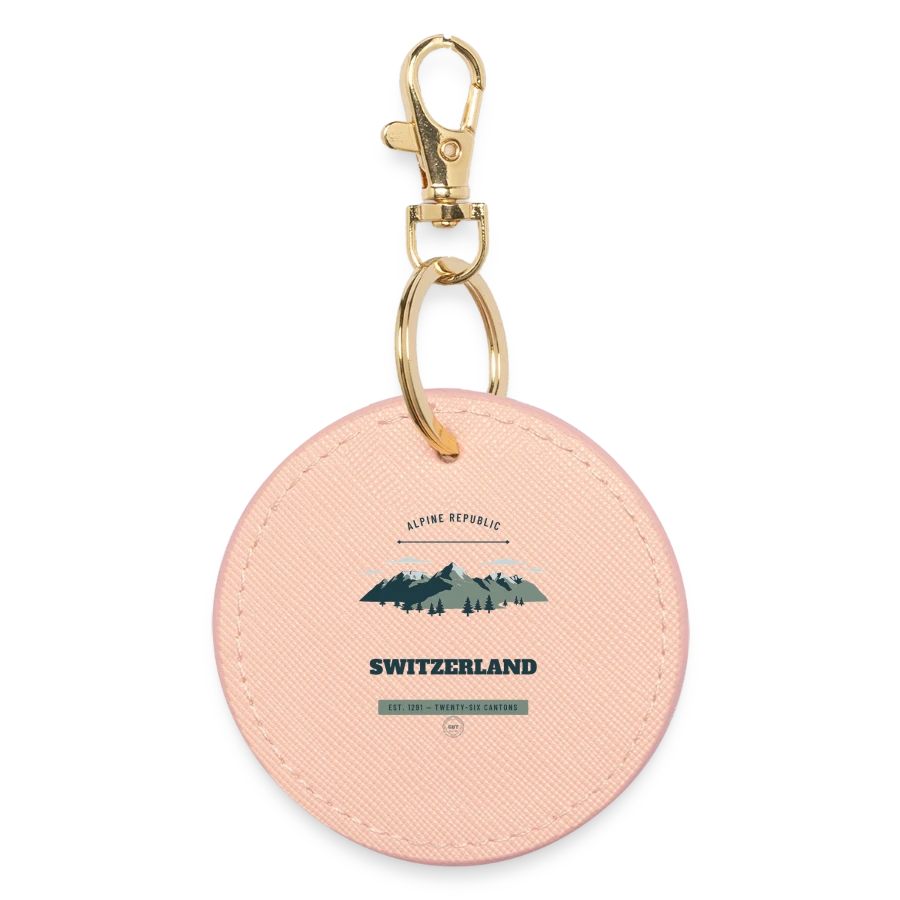 Switzerland badge on a round keyring, light pink