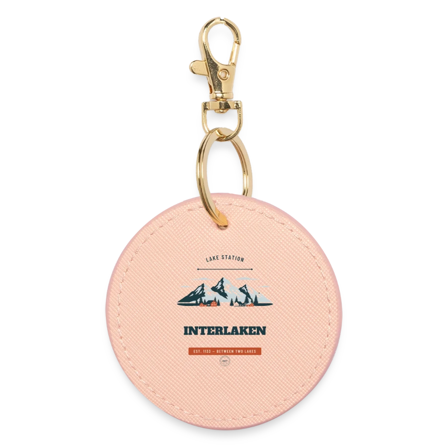 Interlaken badge on a round keyring, light pink