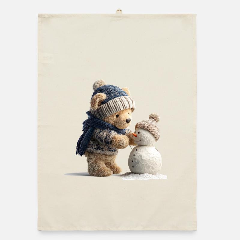 Teddy bear with hat and scarf builds snowman Organic dish towel