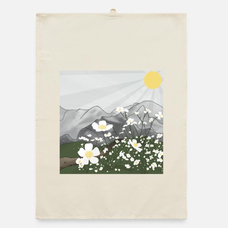 Prairie de fleurs blanches devant le panorama de montagne au printemps Torchon bio