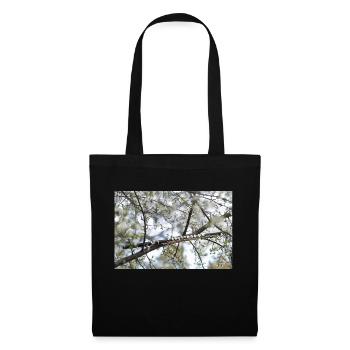 Une flûte noire entre les branches et les fleurs. - Sac en tissu - noir - Devant