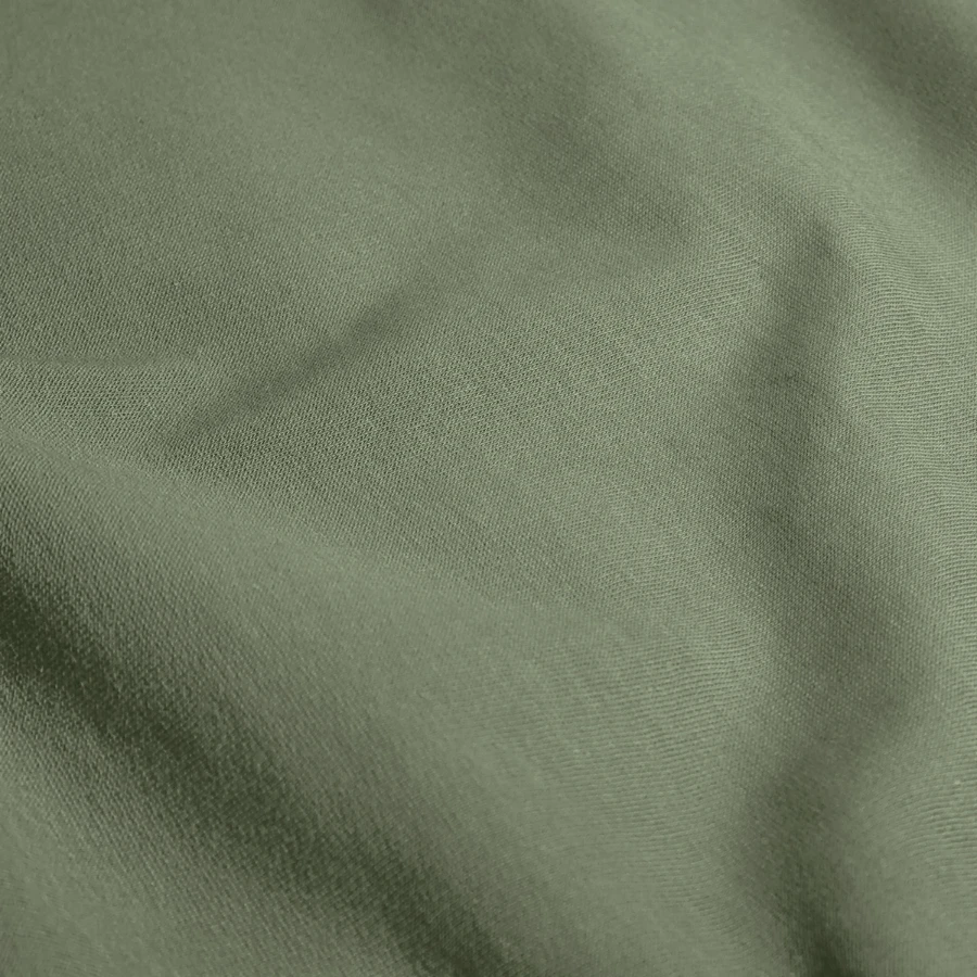 Kraken Island badge on a unisex sweatshirt, army green, close-up
