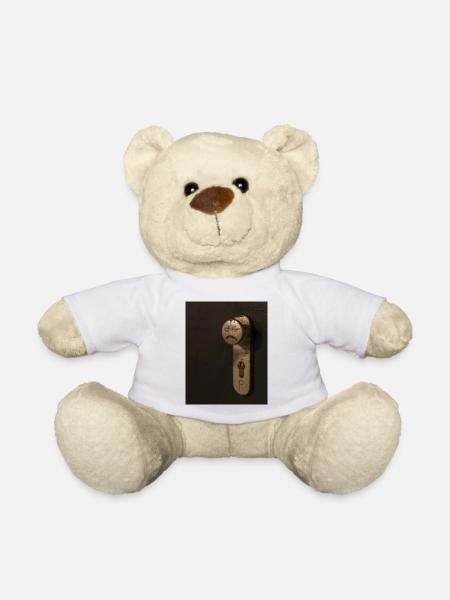A doorknob with a bad tempered face painted on it - Teddy Bear - white