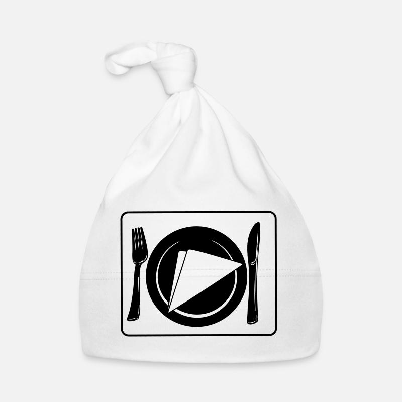 Couteau et fourchette sur napperon avec assiette et serviette Bonnet bio Bébé